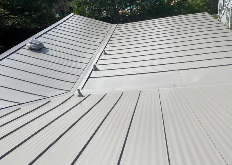 Solar attic fan installed on a metal roof for Roof Ventilation in Woodlawn